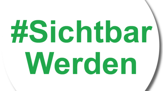 Eine weiße runde Schaltfläche mit dem grünen Text #SichtbarWerden in der Mitte.